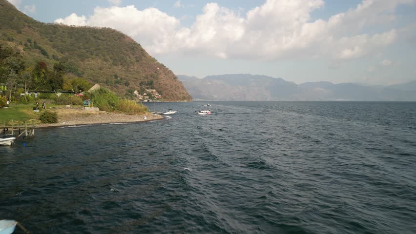 Aerial of small boat docking in Santa Cruz la Laguna Lake Atitlán Guatemala