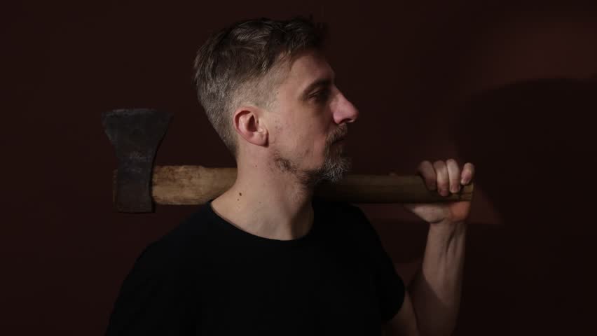 Brutal man with ax on color background