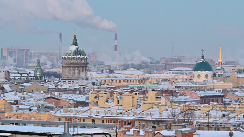 Saint-Petersburg, Russia city center - Kazanskii Cathedral - russian christian church in winter with snow, rooftop sunrise morning view. Heating utilities pipes steaming