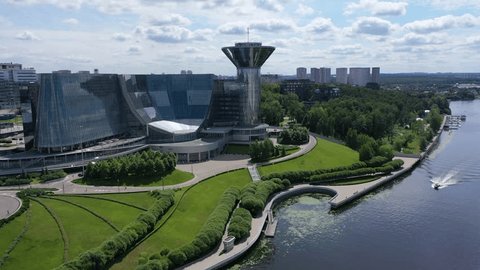 Drone Circling Glass Office Complex by River