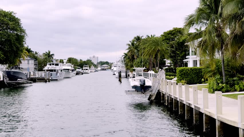 moving shot of boats, yachts and homes along canal in fort lauderdale florida