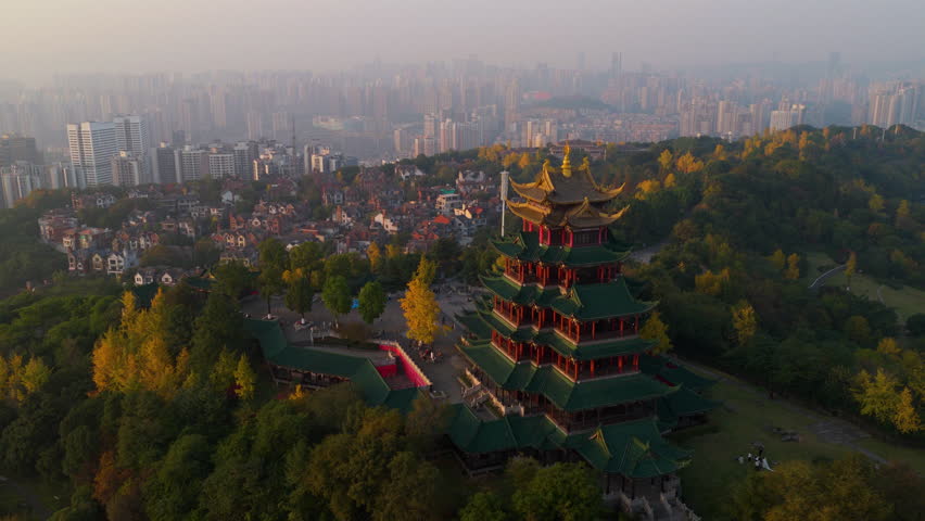 Hongen Pavilion Overlooking The Downtown Chongqing City At Sunset In China. - aerial shot