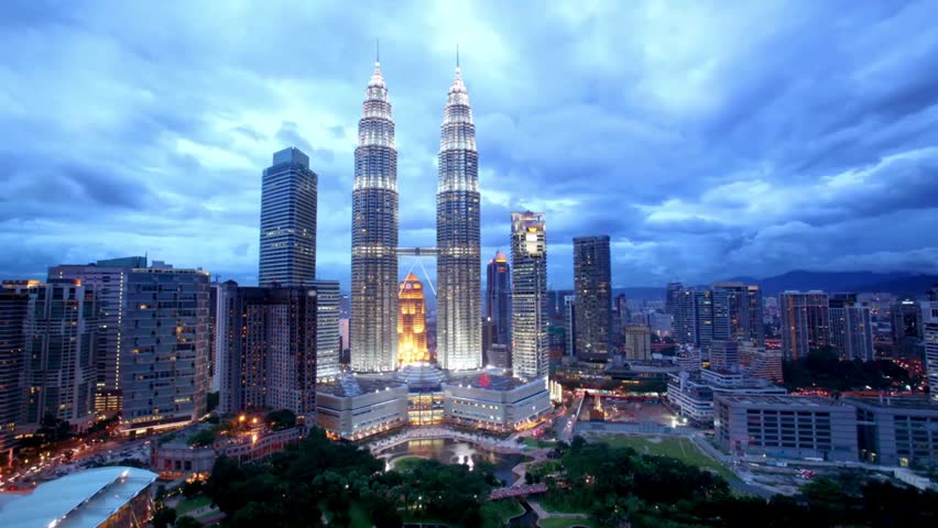 Kuala Lumpur skyline at night with the Petronas Twin Towers, showcasing illuminated skyscrapers, city lights, and vibrant urban nightlife.