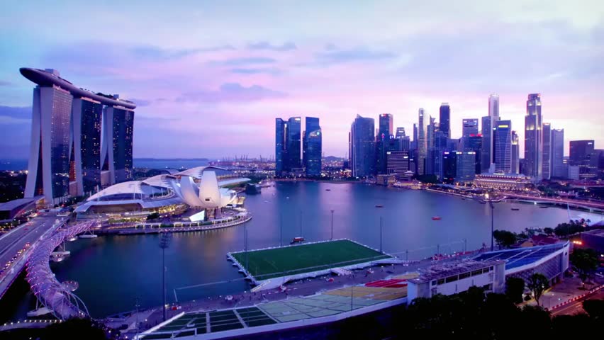 Singapore skyline at dusk with Marina Bay Sands and modern architecture, showcasing city lights, waterfront reflections, and vibrant urban landscape.