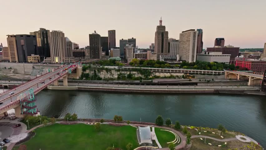 Aerial view of Saint Paul skyline at dusk with the Mississippi River, capturing city lights, bridges, and the scenic urban riverside landscape.