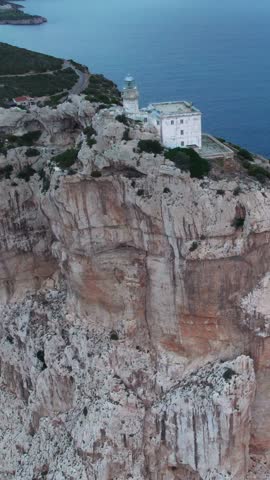 Breathtaking aerial view of the Capo Caccia promontory and its iconic lighthouse in Sardinia, Italy