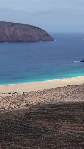 Stunning aerial view of the turquoise ocean and sandy coast of La Graciosa in the Canary Islands