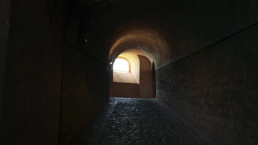 A bright light shines at the end of a dark tunnel, symbolizing hope, journey, transition, or emerging from challenges in cinematic or conceptual visuals.