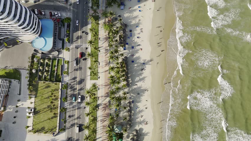 My Khe Beach, Da Nang, Vietnam – 4K aerial drone footage of tropical coastline, sandy beach, palm-lined coastline, ocean waves, and modern city skyline, costal roads, Son Tra Peninsula