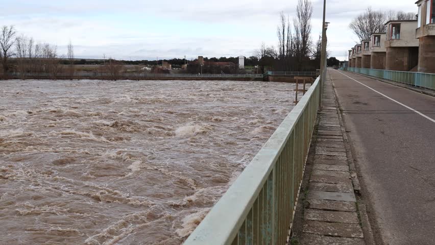 Massive Floodwaters Rushing Beneath Bridge After Excessive Rainfall