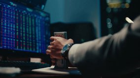 A cinematic shot of a professional stock trader or investor holding a thick bundle of US dollar bills, emphasizing financial success and wealth in a modern office setting - Powered by Shutterstock - Get 15% off with code: PIKWIZARD15