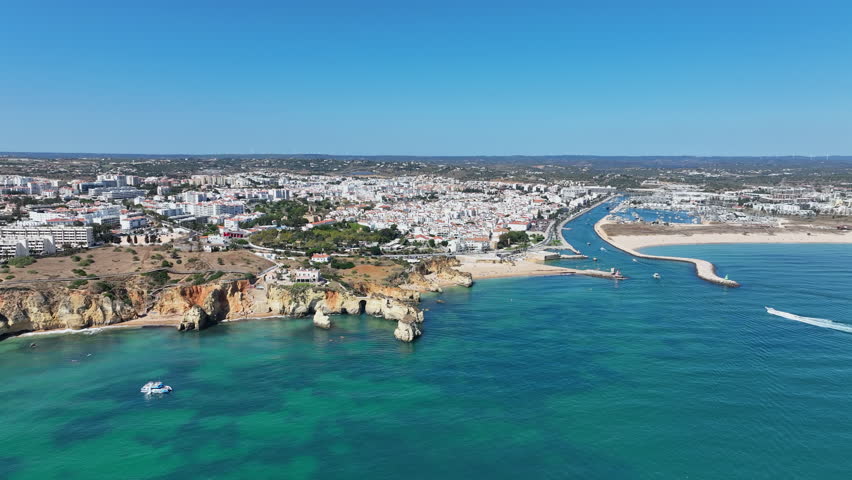 View of the south coast near Lagos in the Algarve, Portugal, showing cliffs, Atlantic Ocean and rugged European shoreline.