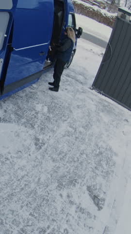 Team Loads Cardboard Boxes From Warehouse in Van. Man Moves Parcels Using Pallet Jack, Trolley While Woman Scans Inventory With Tablet. CCTV, Professional Logistics Process. Timelapse. Vertical Shot.
