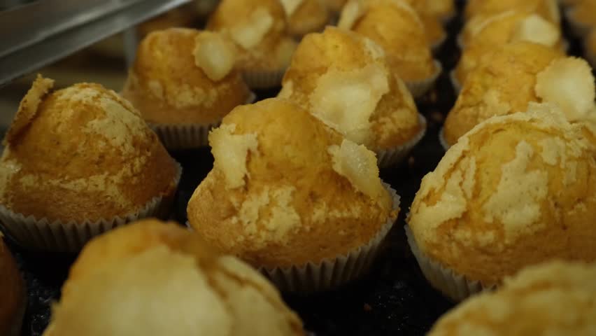 Freshly baked sugar muffins on a tray
