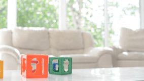 Little cute boy playing at home with toy cubes
