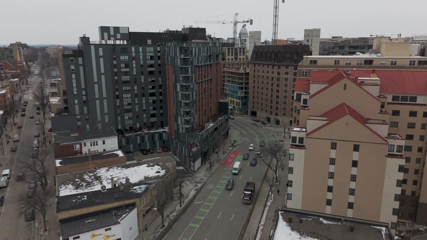 Aerial perspective of downtown Madison surrounded by frozen water and seasonal snow coverage in the American Midwest.