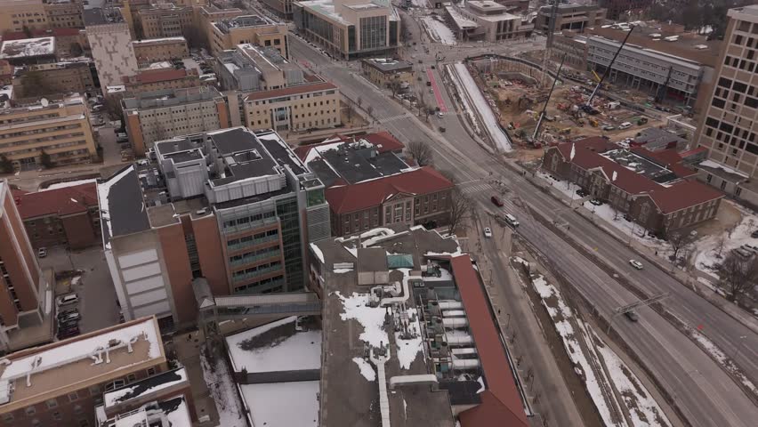 Moody blue hour drone footage of the University of Wisconsin–Madison near Lake Mendota during cold season twilight in Madison.