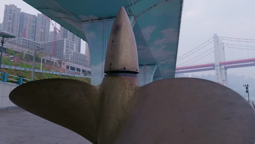 A huge warship propeller on the ground.