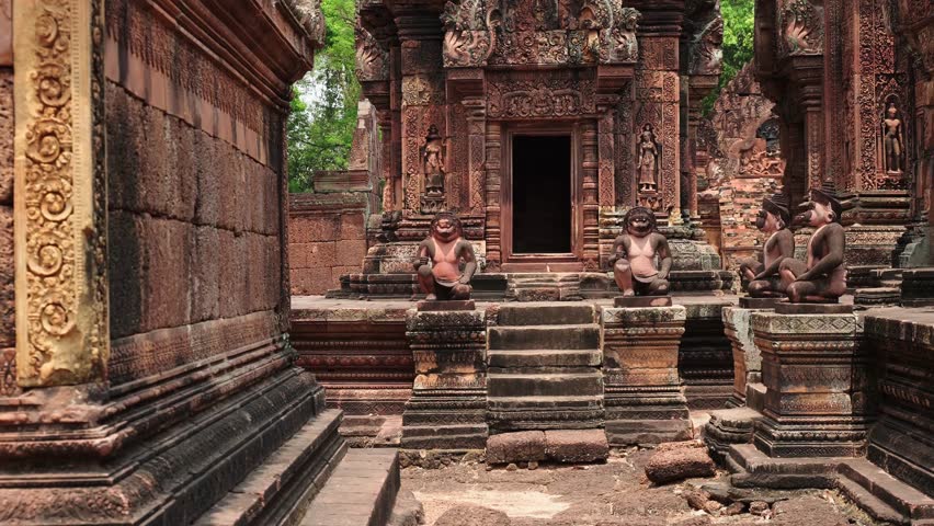 Detailed view of Angkor Wat in Cambodia showing carved stone walls, guardian statues, temple doorway, weathered steps, and historic Khmer architecture