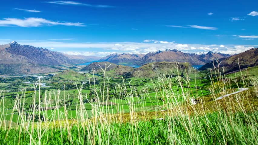Scenic overlook of Queenstown, New Zealand, featuring majestic mountains and lush green valleys, capturing breathtaking natural beauty.