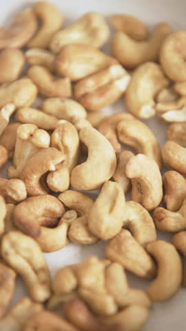 Vertical video with zoom in of a bunch of cashew nuts