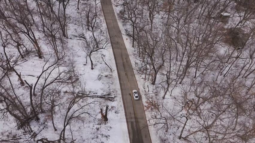 Elevated aerial capturing Madison city, frozen lake, and campus during heavy seasonal snowfall.