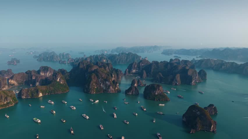 Aerial view of Halong bay with cruise boats and limestone islets, tourist landmark of Vietnam.