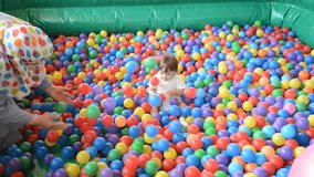 Baby playing in playground colorful ball pool
