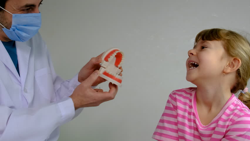 A child at the dentist gets his teeth treated. Selective focus.