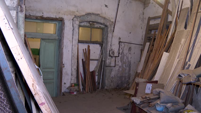 Abandoned Storage Room with Crumbling Walls and Vintage Gas Stove