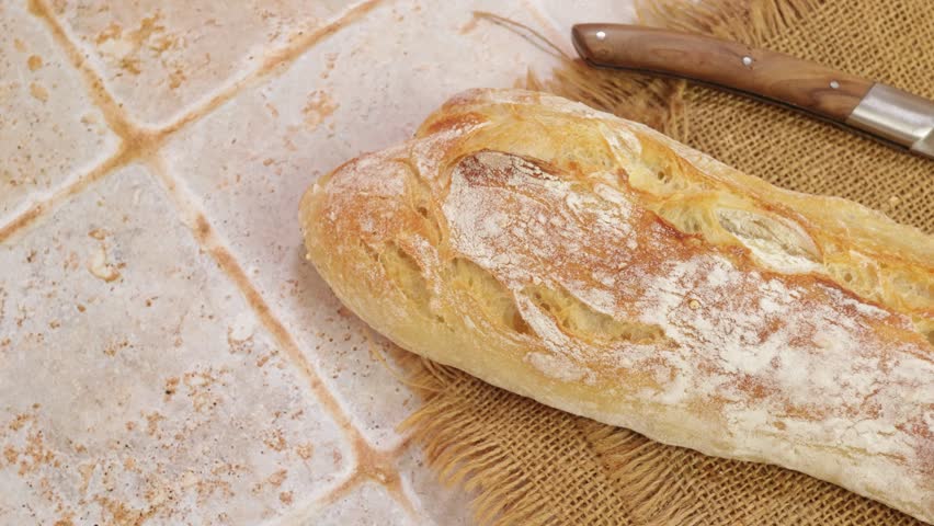 Traditional French baguette on rustic canvas, artisanal bakery and authentic cuisine