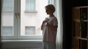 Middle aged woman with closed eyes and hands on chest practicing deep breathing exercise for stress relief and mental health, calming thoughts and body, mindfulness self care, living without anxiety. - Powered by Shutterstock - Get 15% off with code: PIKWIZARD15