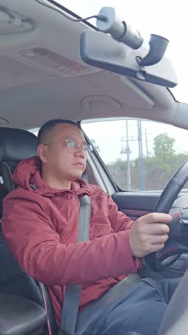 A male driver’s tired and dozing off from long hours of driving.