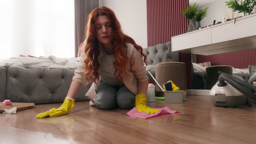 Caucasian woman girl washing wiping floor in home bedroom hotel clean house female girl focusing on sanitation task cleanup living area cleansing with cleaning tools housekeeper housewife with wet rag
