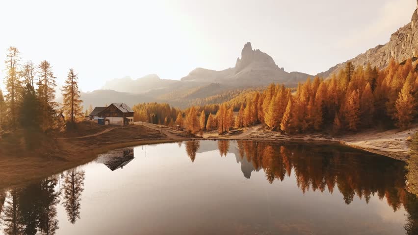 Reflections is in water. Lake Federa near the Croda da Lago mountain at autumn time, majestic landscape, raw nature.