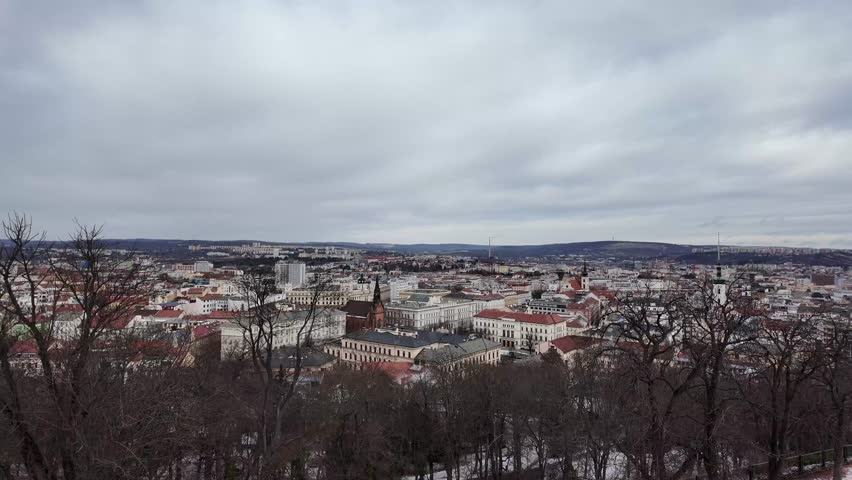 Cinematic slow motion wide shot of Brno city skyline from Spilberk Castle during a snowy winter day, Czech Republic.