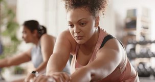 Diverse female friends doing forward fold, lifting arm into side stretch at studio on yoga mats. Fitness, wellness, community, flexibility, mindfulness, strength, collaboration - Powered by Shutterstock - Get 15% off with code: PIKWIZARD15
