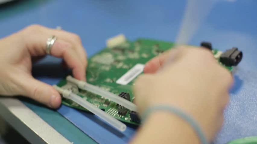 Close-up examination of a circuit board during assembly process in a high-definition setting