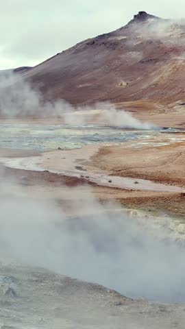 Volcanic landscape with mountains, steaming hot springs and geothermal activity in Hverir, Iceland