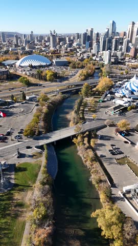 Vertical aerial drone view of downtown Calgary skyline and Elbow River in Autumn, Alberta Canada