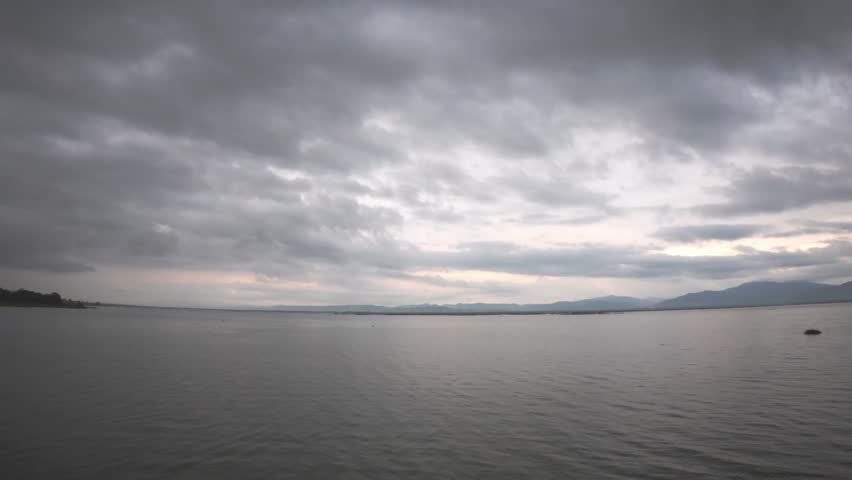 Overcast Sky Over Calm Lake and Mountains