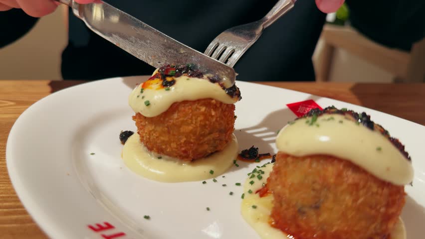 Chicken confit croquettes with parmesan cheese topped with creamy truffle sauce. High quality 4k footage