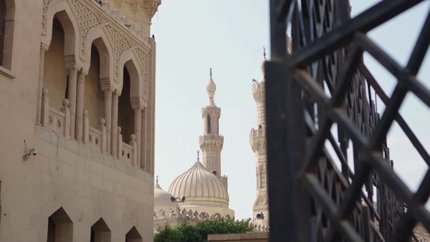 Ancient Al Azhar mosque architecture in cairo, egypt, features a historic minaret and landmark tower against a clear sky, blending religion and tourism in this historic arabian city monument