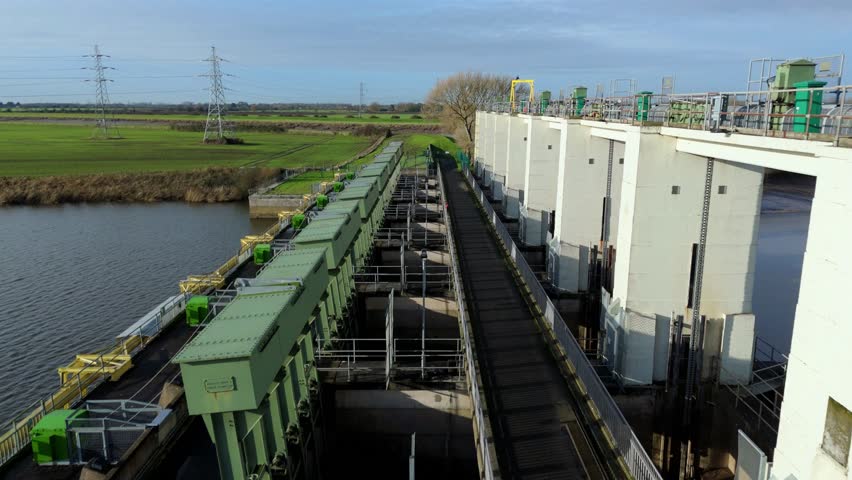 Aerial view of an industrial river dam near Kings Lynn in the United Kingdom.