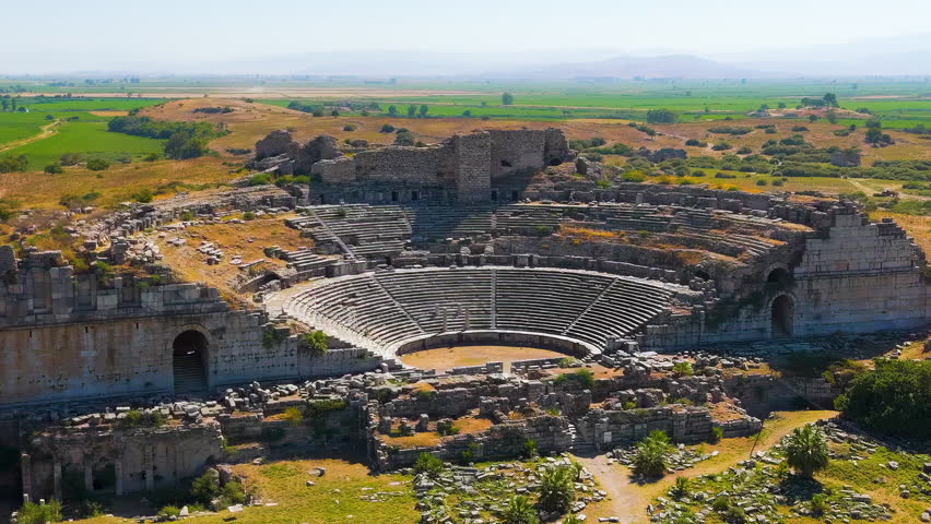Dolly zoom. Balat, Turkey. Aerial drone view of the ancient Theatre of Miletus and Ilyas Bey Kervansarayi, archaeological site in Turkey. Aerial View. Rich colors