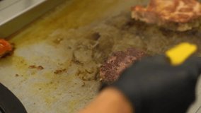 Chef adding cheese to a hamburger patty or pork chop on a hot griddle in a restaurant kitchen - Powered by Shutterstock - Get 15% off with code: PIKWIZARD15