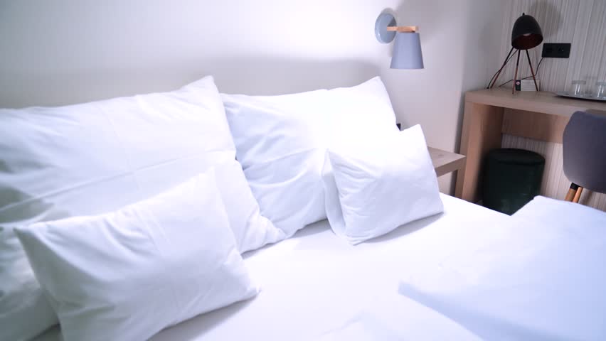 Hotel room with comfortable bed and desk setup, offering hospitality and rest, Modern hotel room interior providing comfort, accommodation, and a relaxing environment for guests