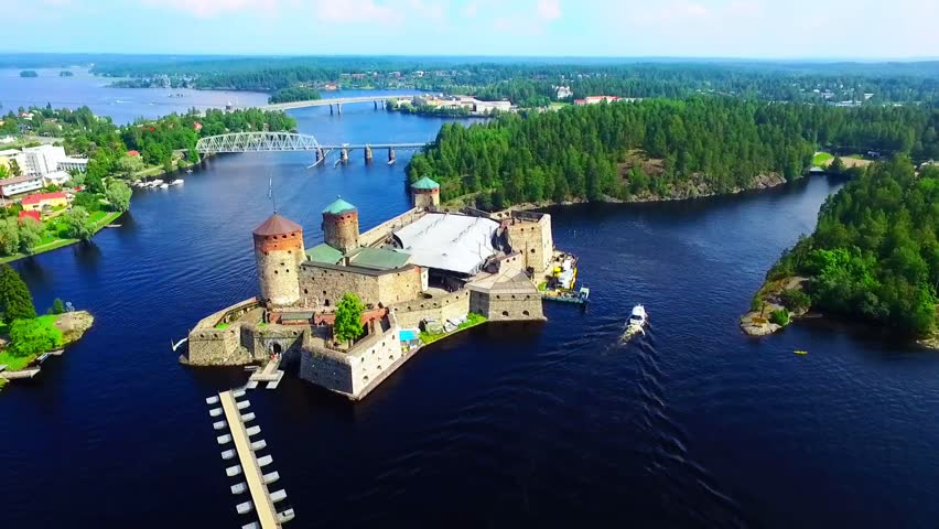 Aerial view of Olavinlinna Medieval Castle in Savonlinna. Enchanting Island Castle Surrounded by Lush Greenery and Tranquil Waters in Finland