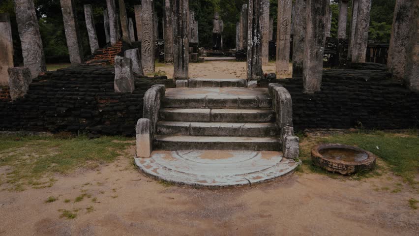 Stone staircase with moonstone carvings leading to Buddha statue at Vatadage temple in Polonnaruwa, Sri Lanka