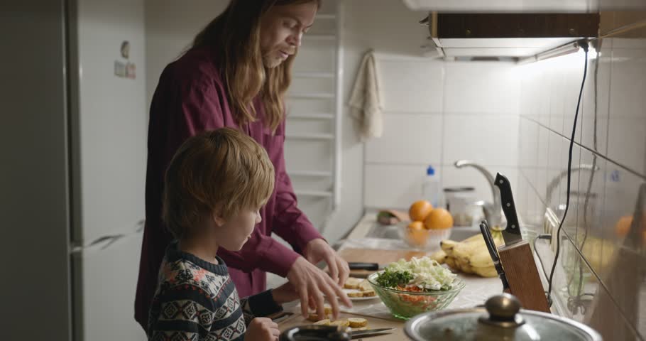 Man and Child Prepare Meal in Kitchen Food for Family Dinner or Supper. 4K 10-bit